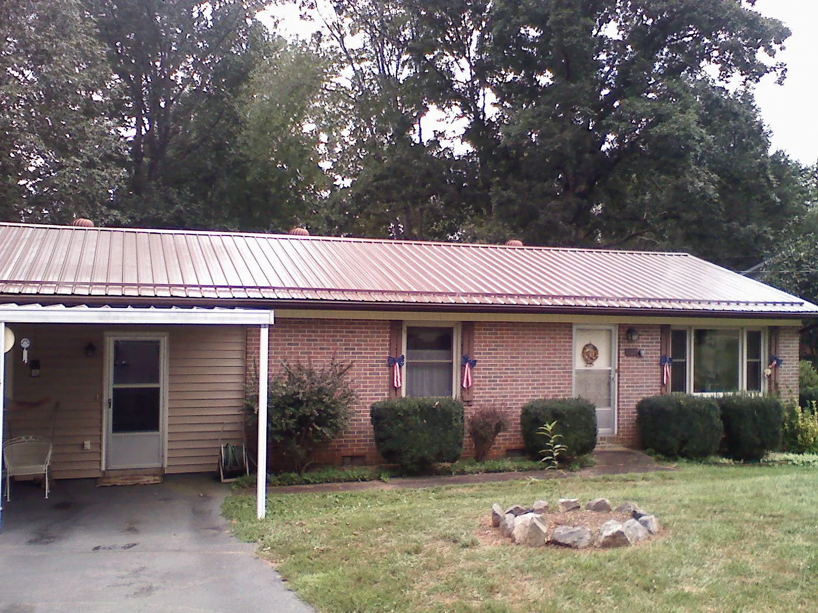 Bronze metal roof and carport on a brick ranch home — Roof Repair work by our crew in Bayside